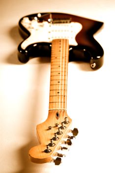 Electric guitar with orange lighting and shallow depth of field.  