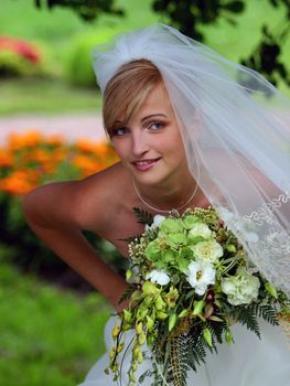 Portrait of beautiful bride in traditional wedding dress and veil.