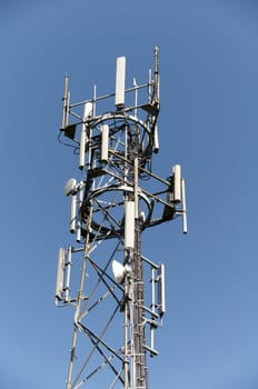 A phone mast against a clear blue sky