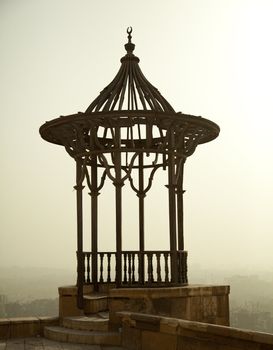 Old iron viewing place in the Citadel in Cairo in Egypt overlooking a misty and smoggy city
