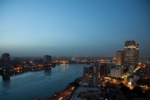 Smoggy evening panorama across Cairo in Egypt with the river Nile