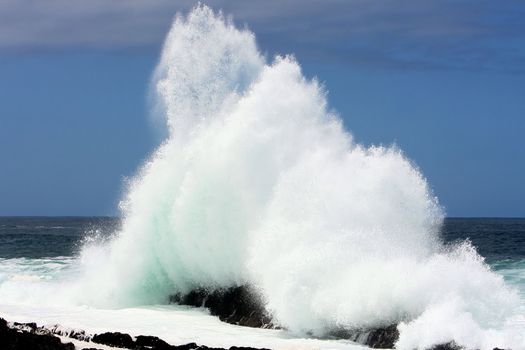 Wave crashing off rocks on the South African coast line