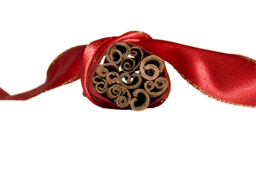 close-up on a bunch of cinnamon rolls tied with red ribbon, isolated on white