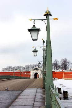 Peter and Paul Fortress, the bridge with lights, a fence on the bridge, dove, the entrance to krepos, the gate to the fortress, a symbol of Russia, a symbol of St. Petersburg