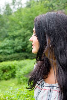 Beautiful girl resting in the summer garden.