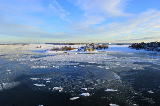 Icy Baltic sea around Helsinki, with Finnish houses on islands