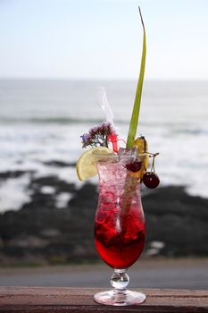 Tropical cocktail drink in a tall glass with lots of ice