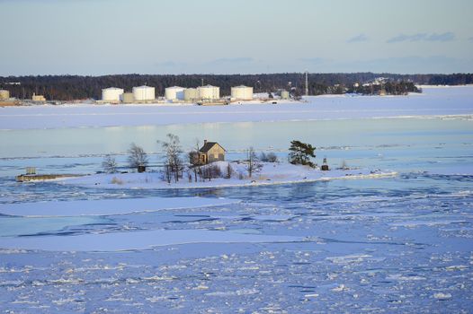 Icy Baltic sea around Helsinki, with Finnish houses on islands