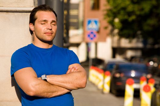 Caucasian resting man standing on the streets 