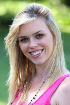 Portrait of a lovely blond lady with a big smile