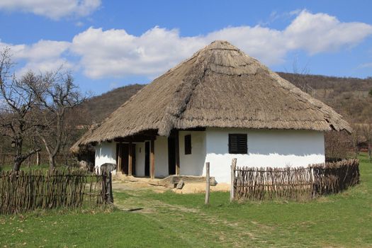 Rural thatched roof house in the hills.