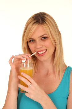 Beautiful blond girl smiling and sipping fresh orange juice