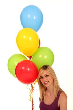 Beautiful blond girl holding a colorful bunch of balloons