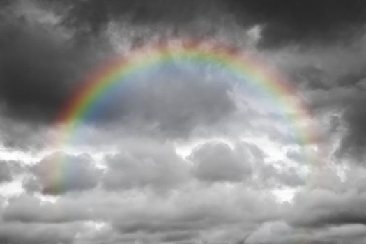 A photography of a dark sky background with a colorful rainbow