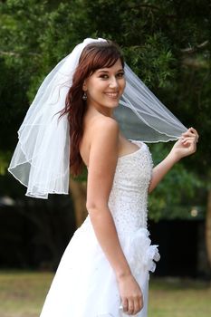 Stunning bride with lovely smile in a beautiful wedding dress