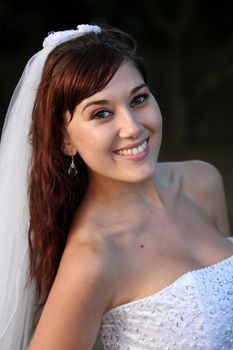 Stunning bride with lovely smile in a beautiful wedding dress