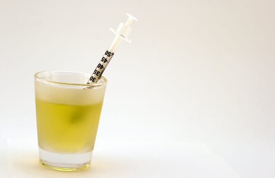 shot glass with syringe isolated on a white background