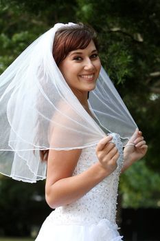 Stunning bride with lovely smile in a beautiful wedding dress