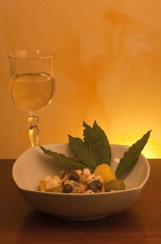 octopus salad with olives on orange gradient background
