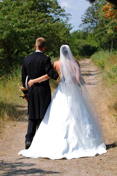 Wedding couple walking. The couple is standing with the back.