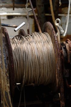 Rusty fishing winch on a deck of a shrimp boat.