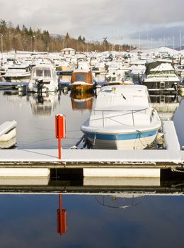 Snow on boats in marina