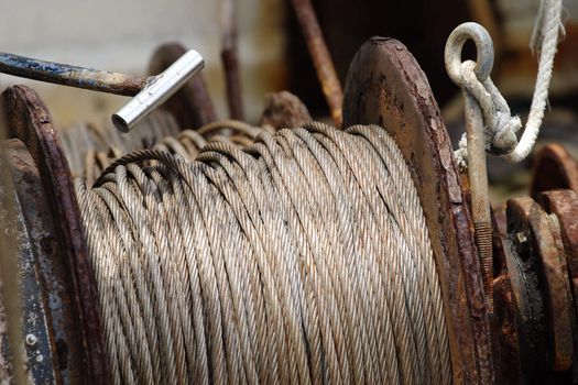 Rusty fishing winch on a deck of a shrimp boat.