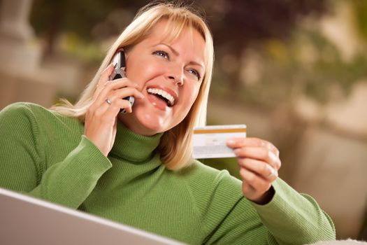 Cheerful Woman on Her Phone and Laptop with Credit Card.