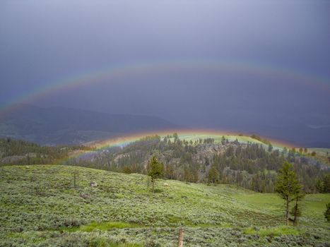 Double rainbow arcs Lamar Valley after a storm