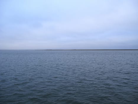 Simple dark bay water and cloudy sky