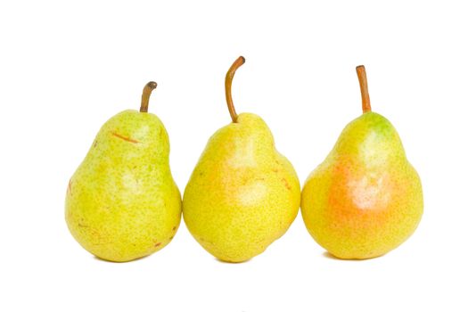 Three delicious yellow pears isolated on a white background.