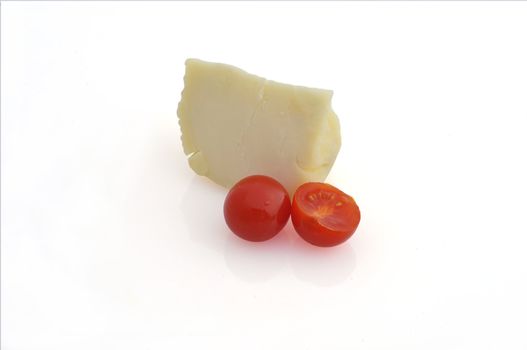 a piece of cheese and tomatoes on white background