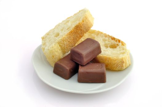 Bread and chocolate on a plate on a white background