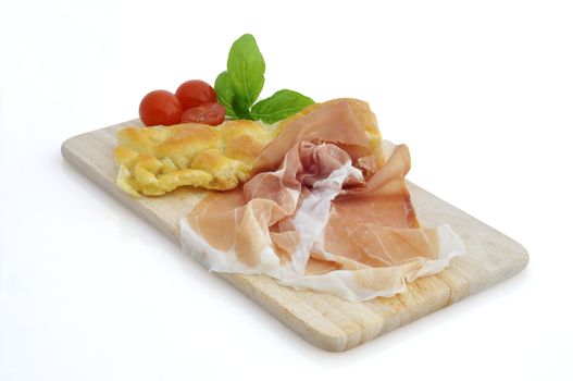  tomatoes ,ham and basil leaves on a white background