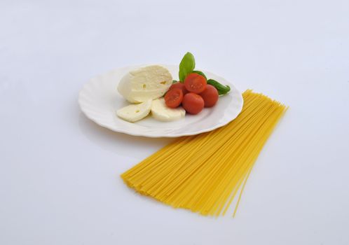 cheese, tomatoes and pasta on white background