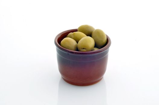 a container with olives on a white background