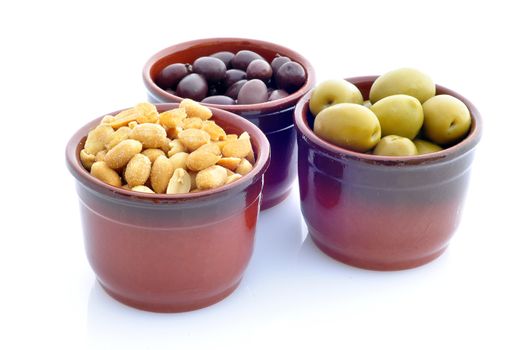 containers with olives and peanuts on a white background