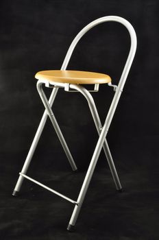 wooden folding stool chiaroe steel on a black background