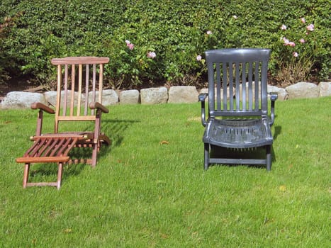 Relaxation sunbathing chairs in a yard garden
