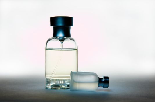 Two perfume bottles, on gradient background
