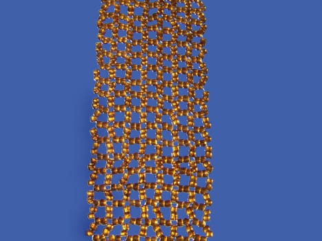 Close up of brown beads at blue background.
