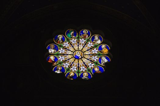 Religious themed stained glass window in Rome, Italy.