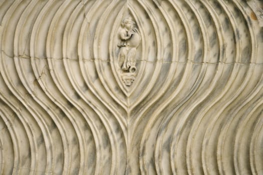 Close-up of engraved couple surrounded by line pattern in Rome, Italy.