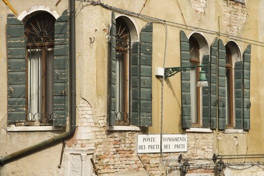 Arched windows with shutters in Venice, Italy.