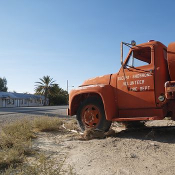 Old fire truck abandoned in desolate town.