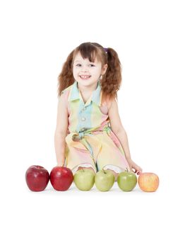 A happy girl playing with apples sitting on white background