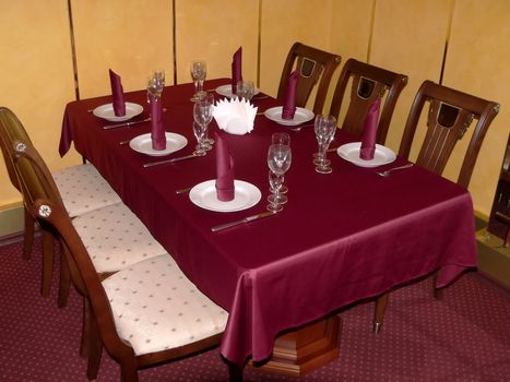 Table with crimson tablecloth.