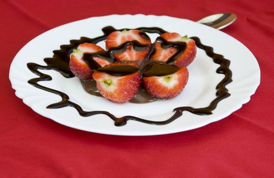 lovely arrangement of strawberries in chocolate, red background