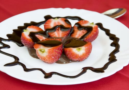 lovely arrangement of strawberries in chocolate, red background