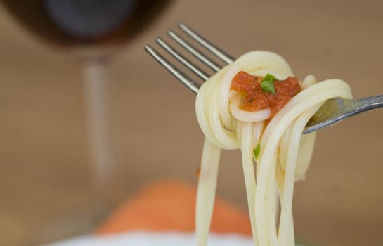 freshly made spaghetti rolled on fork